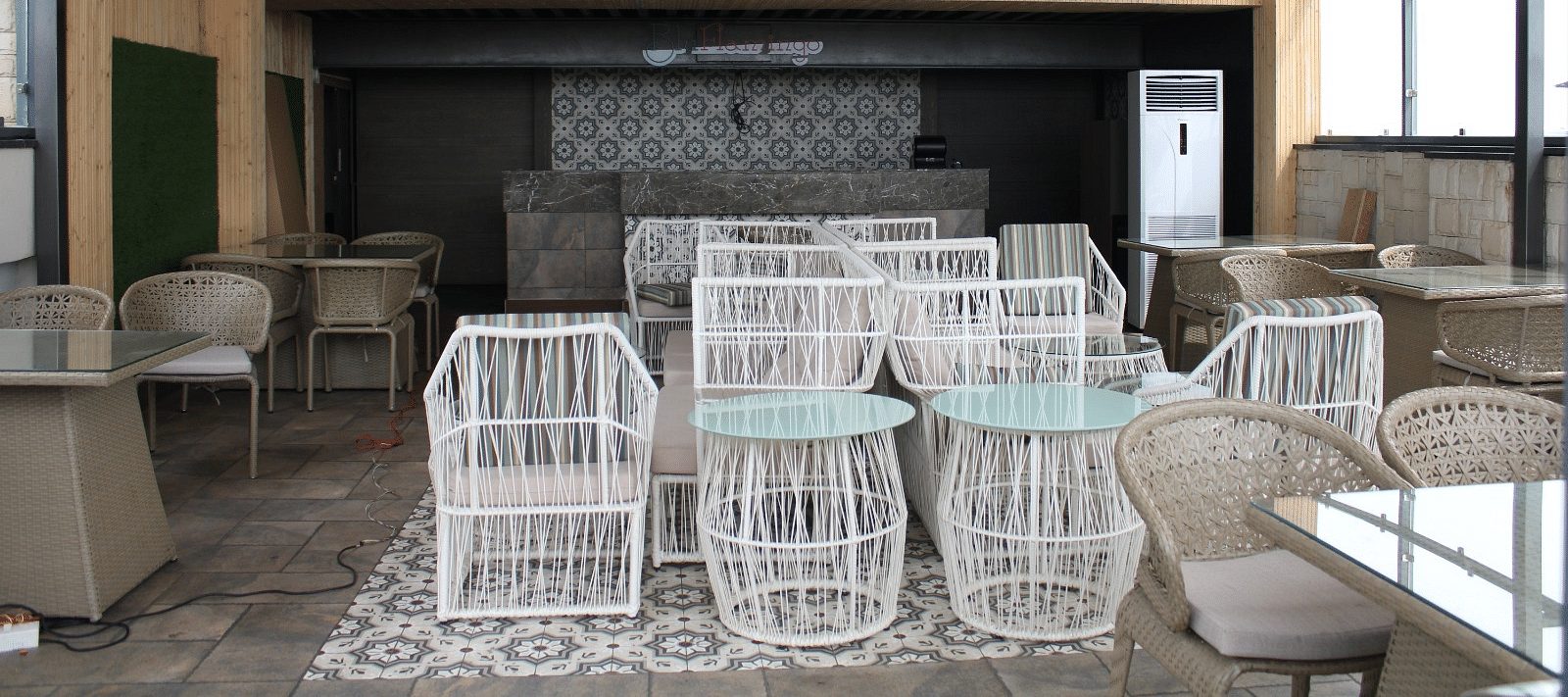 A lounge with chairs arranged neatly and ambient lights hanging from the ceiling at  BluSalzz Residence, Amritsar